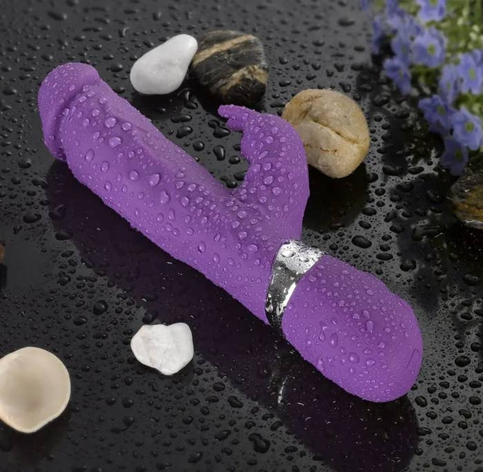 Dark purple vibrator with a curvy shaft and bunny-shaped flicker on the side