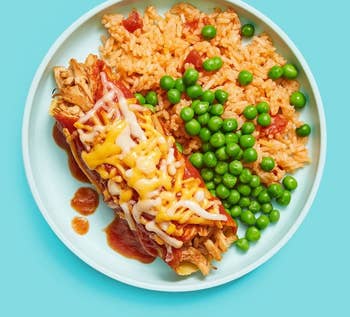 an enchilada with rice and peas