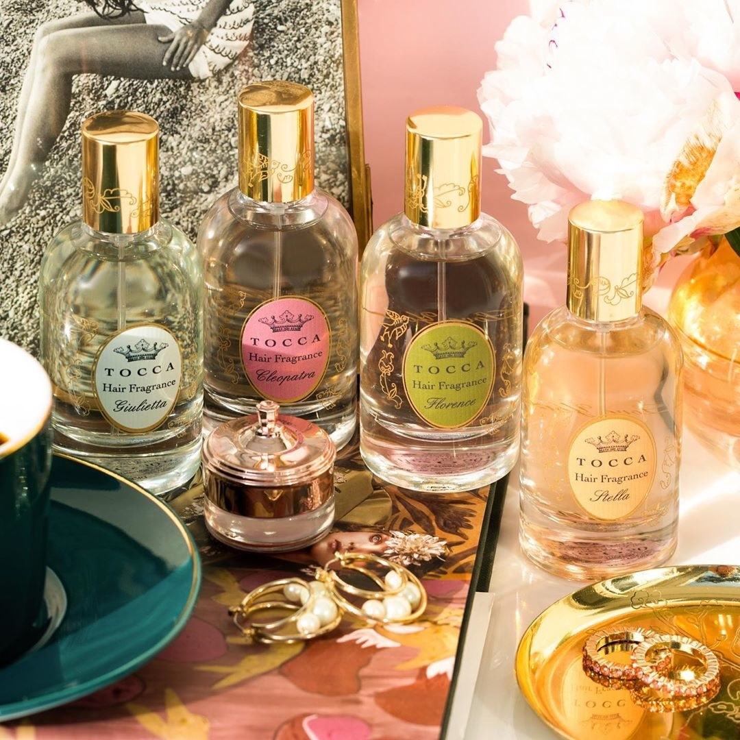 A vanity counter with four differently-scented of hair fragrance
