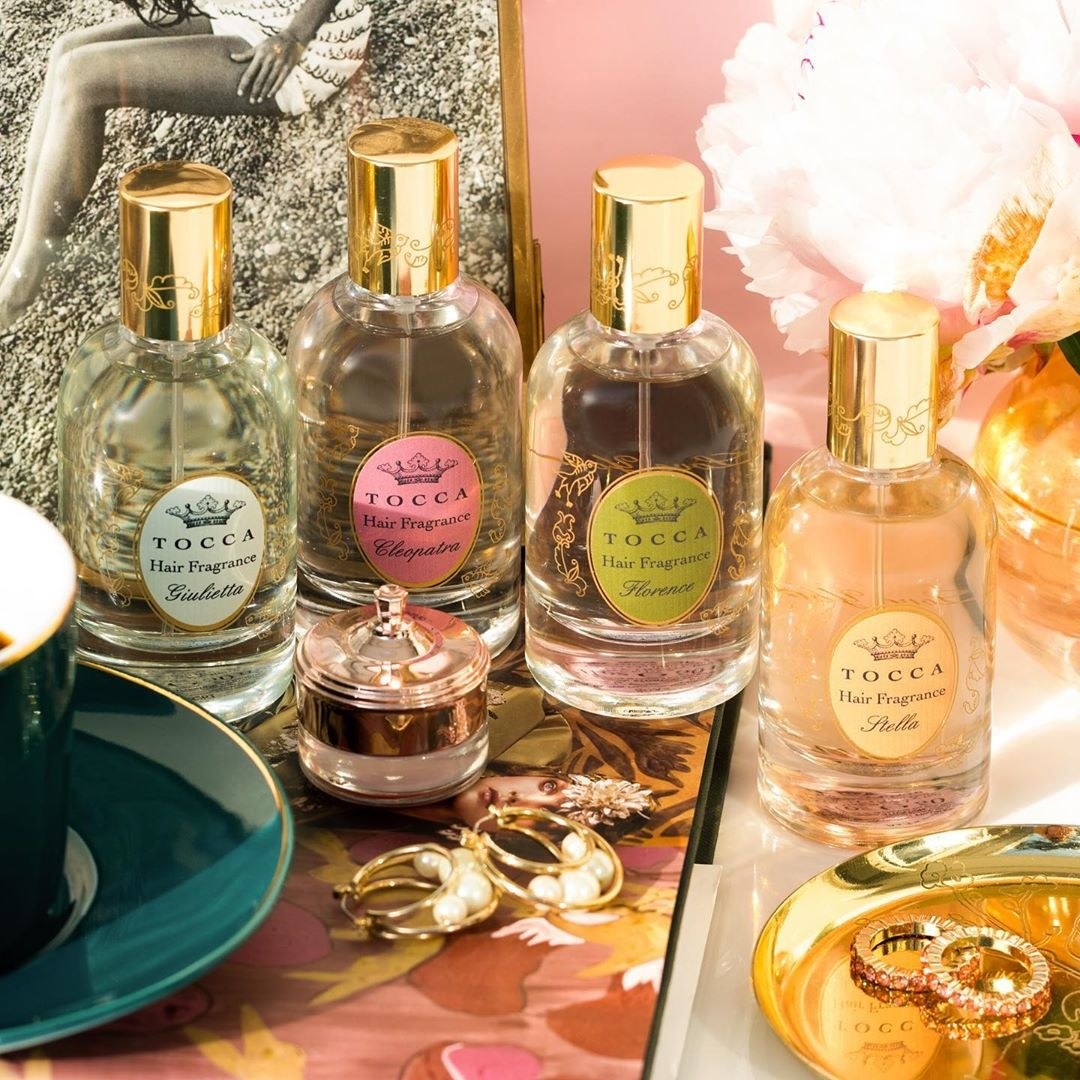 A vanity counter with four differently-scented of hair fragrance