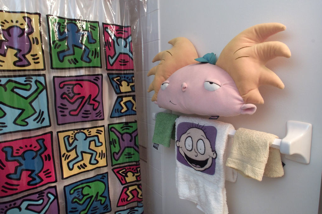 Bathroom with a Keith Haring shower curtain and &quot;Rugrats&quot; hand towel