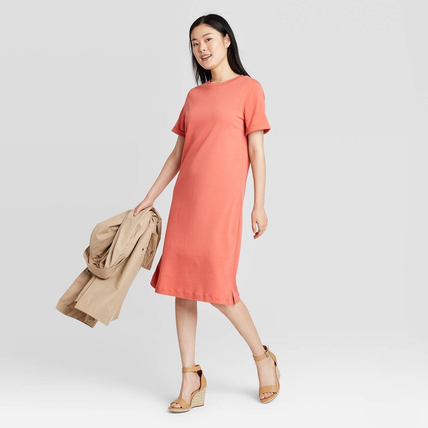 Model wearing the dress in coral 