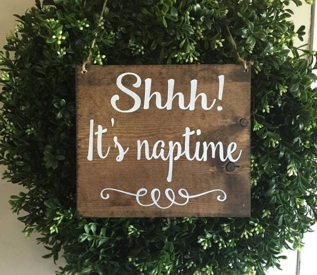 wooden sign on front door that says shh it's naptime