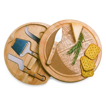 round wood cheese board with top swiveled forward, showing the inside with cheese tools that fit into holes perfectly, and the etching of a Death Star on top