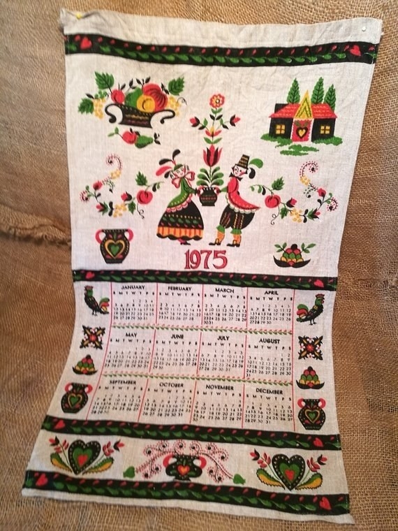 A cloth calendar from 1975 with folksy illustrations