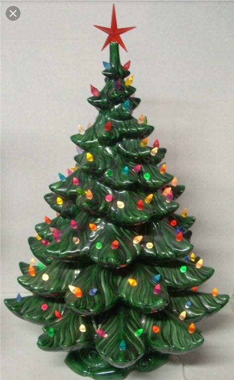 Close-up of a ceramic Christmas tree with lights