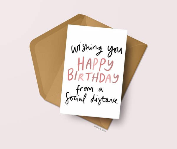 A card that says "wishing you a happy birthday from a social distance" with an envelope