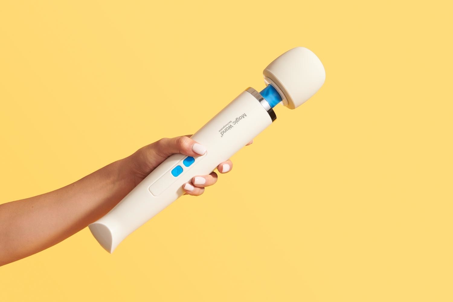 Hand holding vibrator to show large massage head and long handle