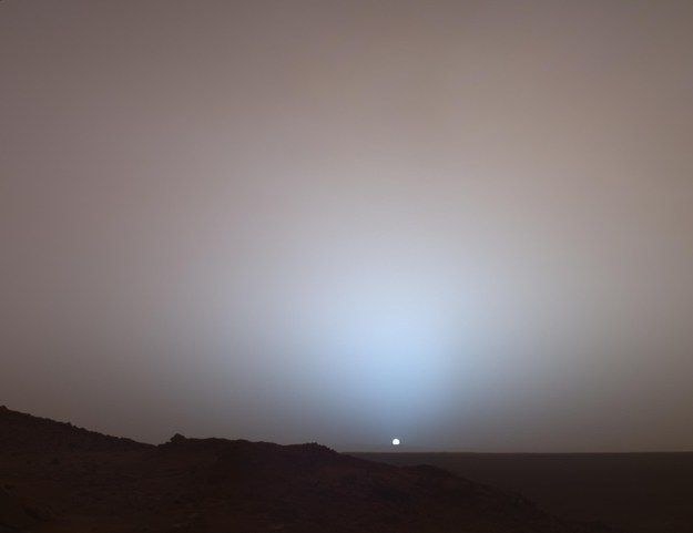 Sunset captured by a rover on the Martian horizon with dusty sky