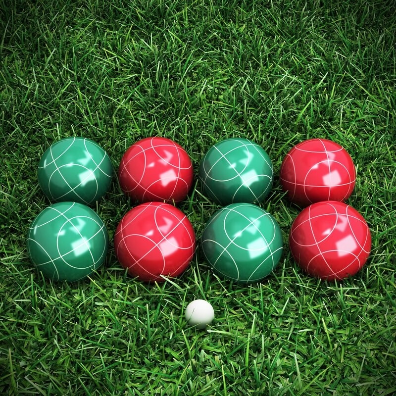 A set of four green and four red bocce balls and a white pallino ball