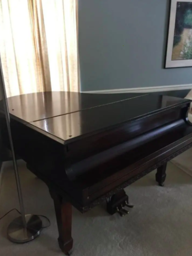 A baby grand piano in a room