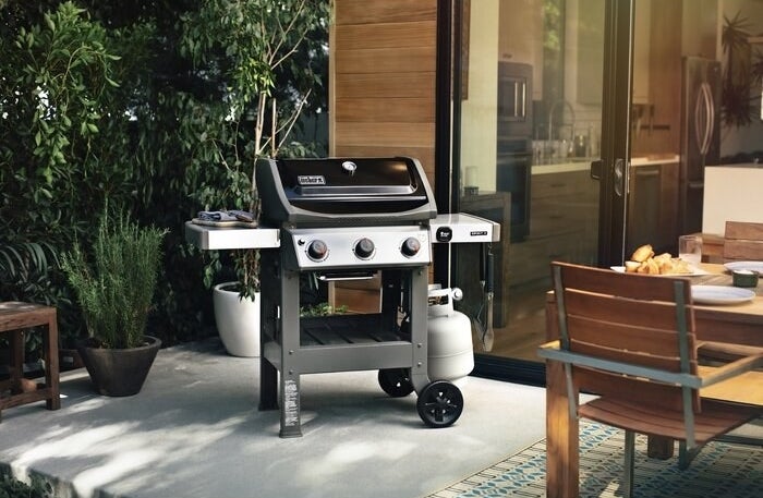 Gas grill set up on outdoor patio 