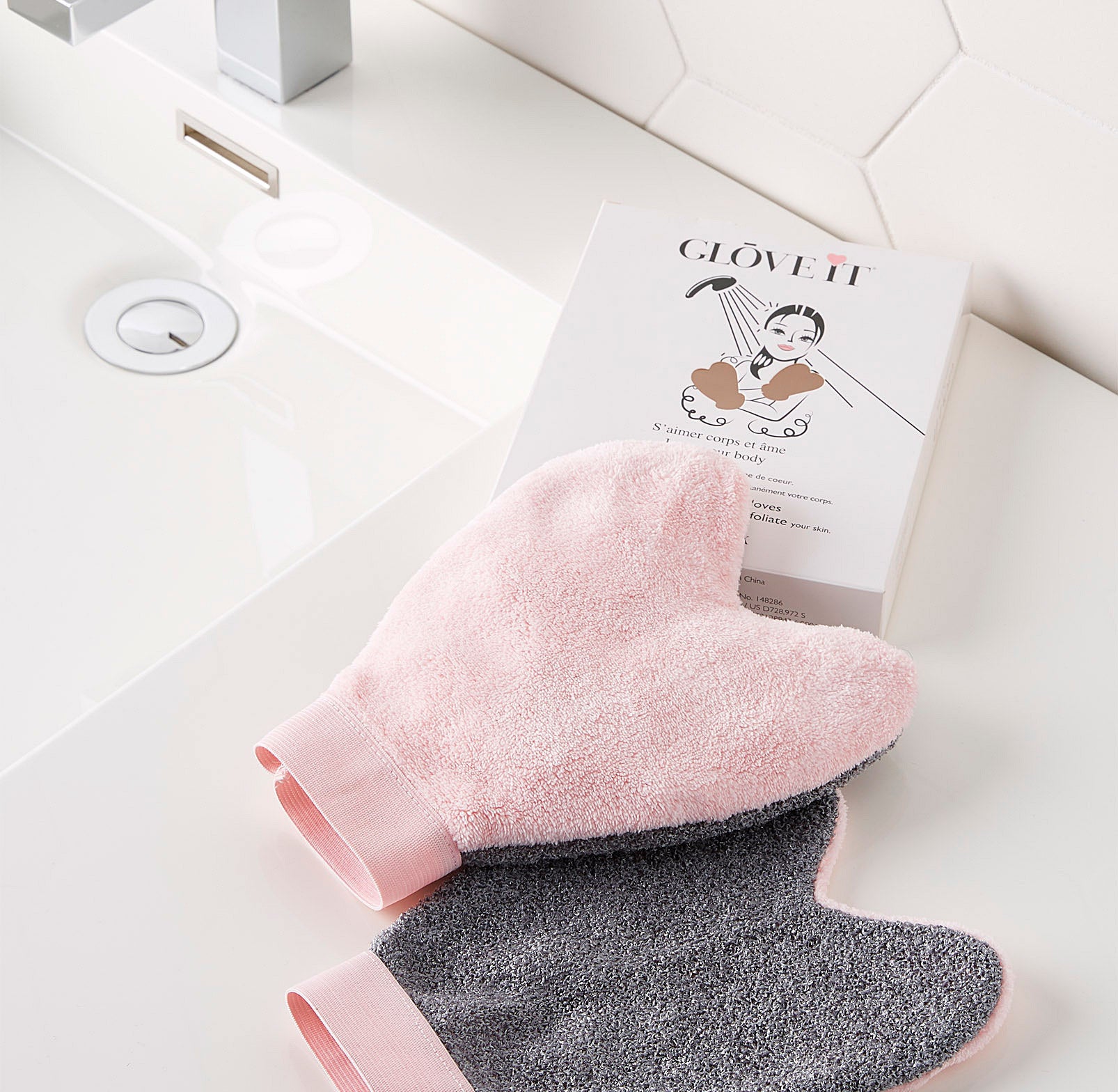 A pair of soft cloth wash gloves on a bathroom counter