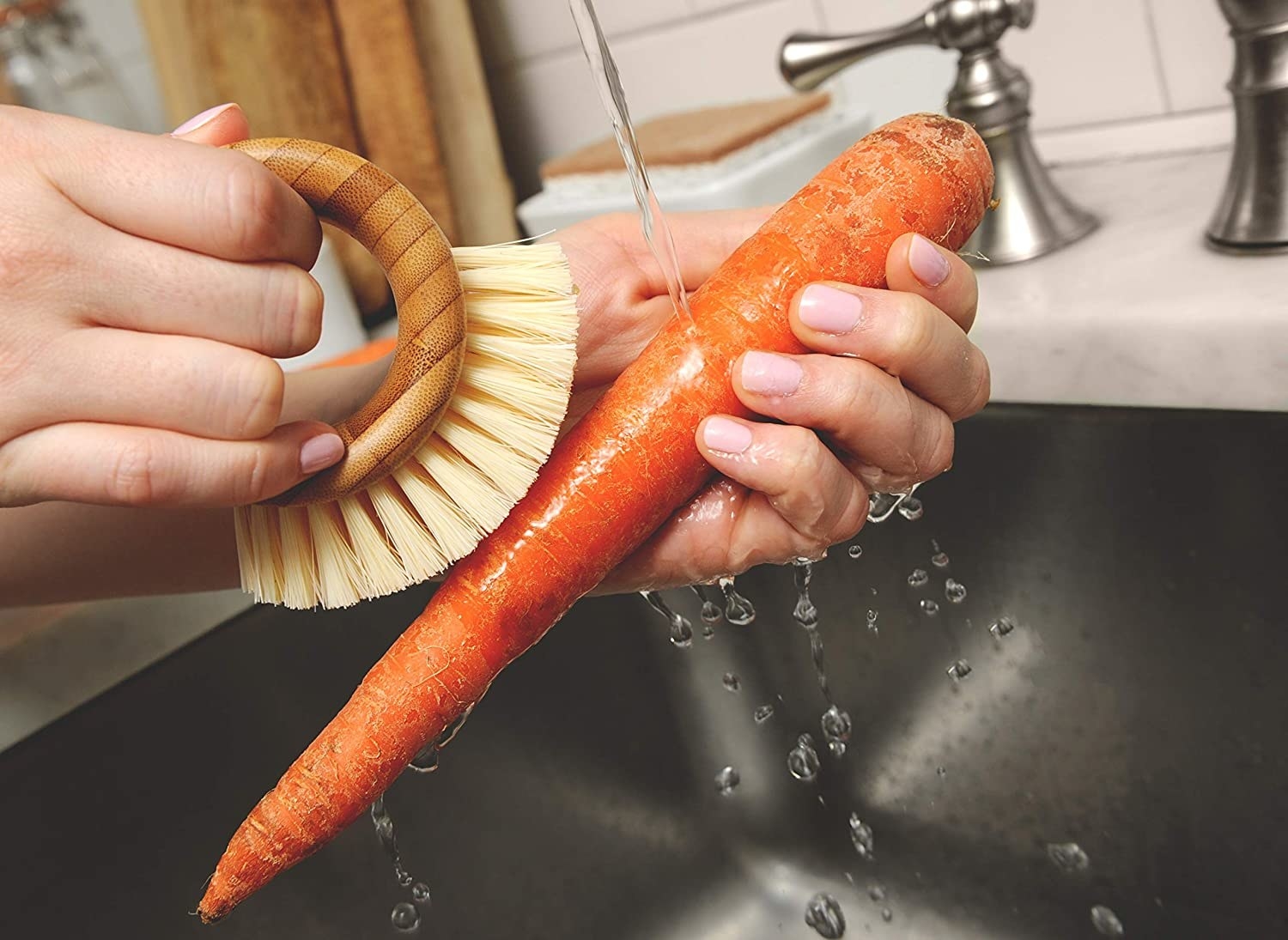 Model using vegetable brush to wash carrot