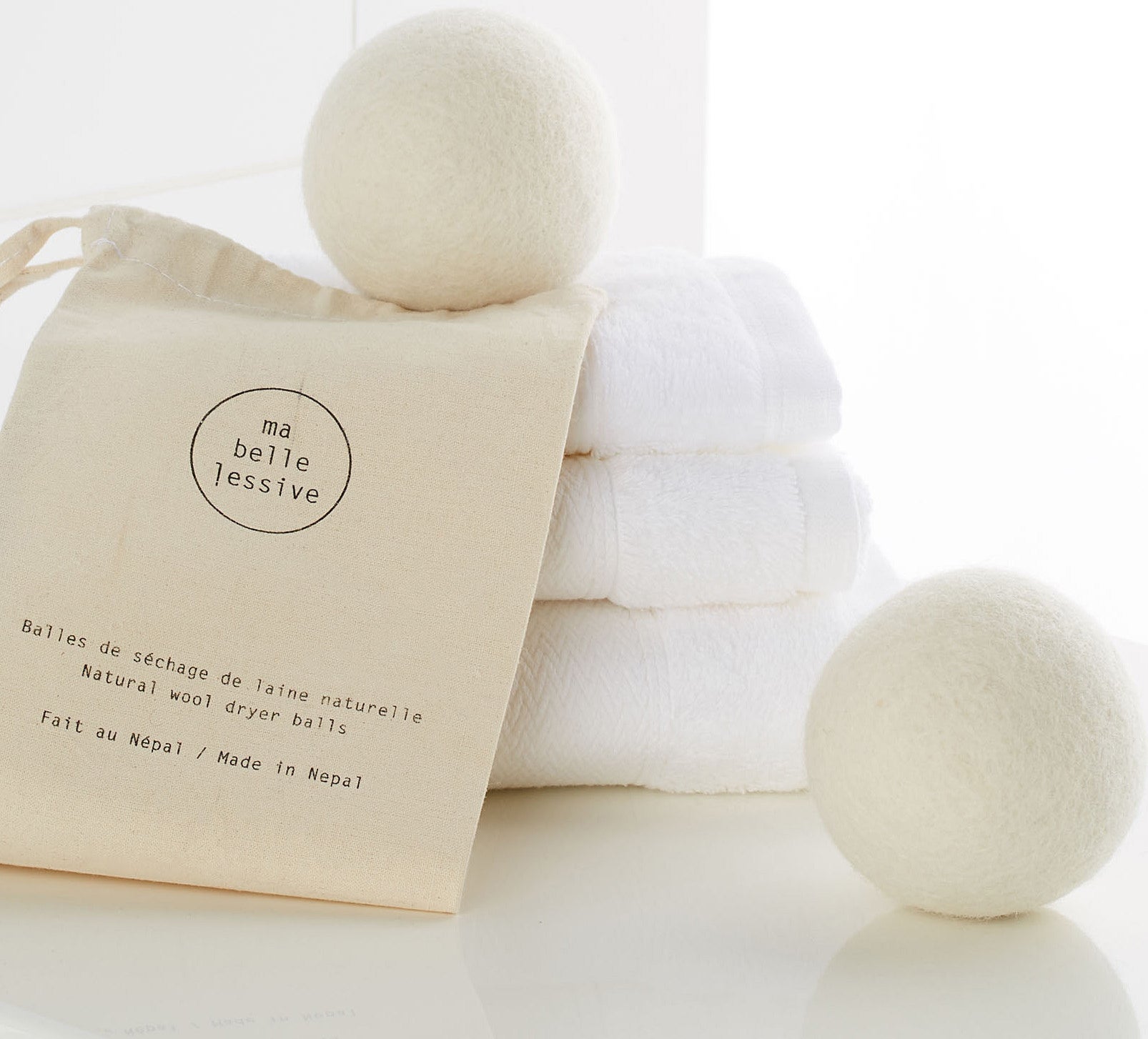 Two wool balls on a stack of towels