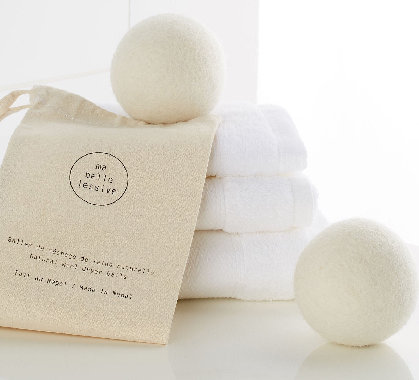 Two wool balls on a stack of towels