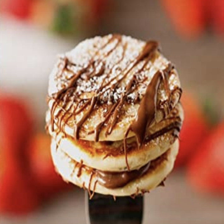 a stack of pancakes with chocolate drizzle 