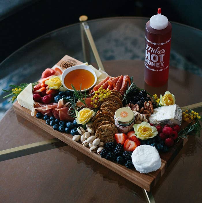 Dish of hot honey on a cheeseboard for drizzling and dipping