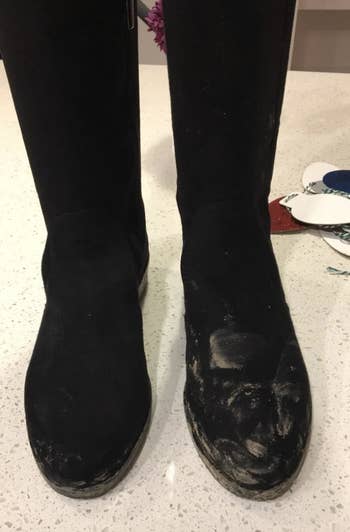 reviewer photo of suede black boots and one boot has significant scuff marks 