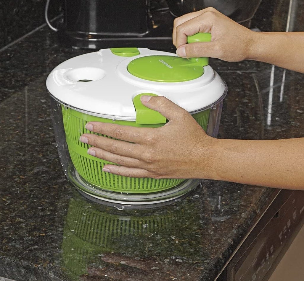 green salad spinner with white cover 