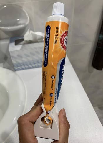 closeup of the holder and the toothpaste rolled into it