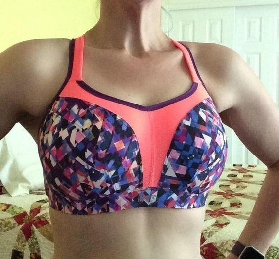 image of reviewer wearing purple patterned sports bra, which has a hot pink center