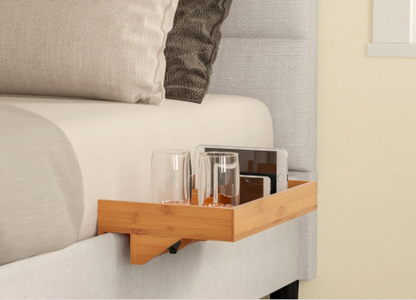wooden shelf attached to the side of a bed