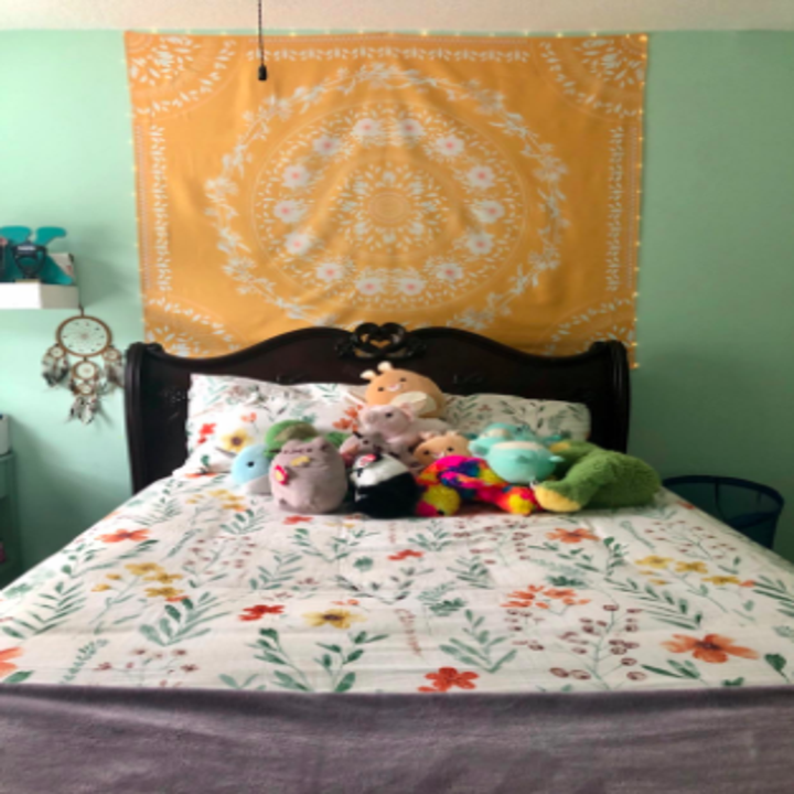 another reviewer's pic with an orange mandala tapestry hung up on the wall behind the bed
