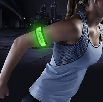 Model wears green glow-in-the-dark armbands while working out at night