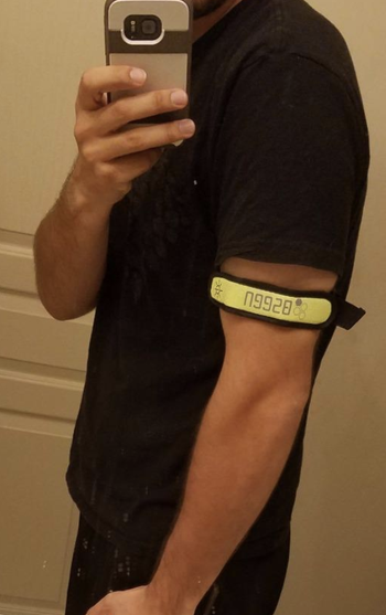 Reviewer wears same arm bands in a yellow color before running at night