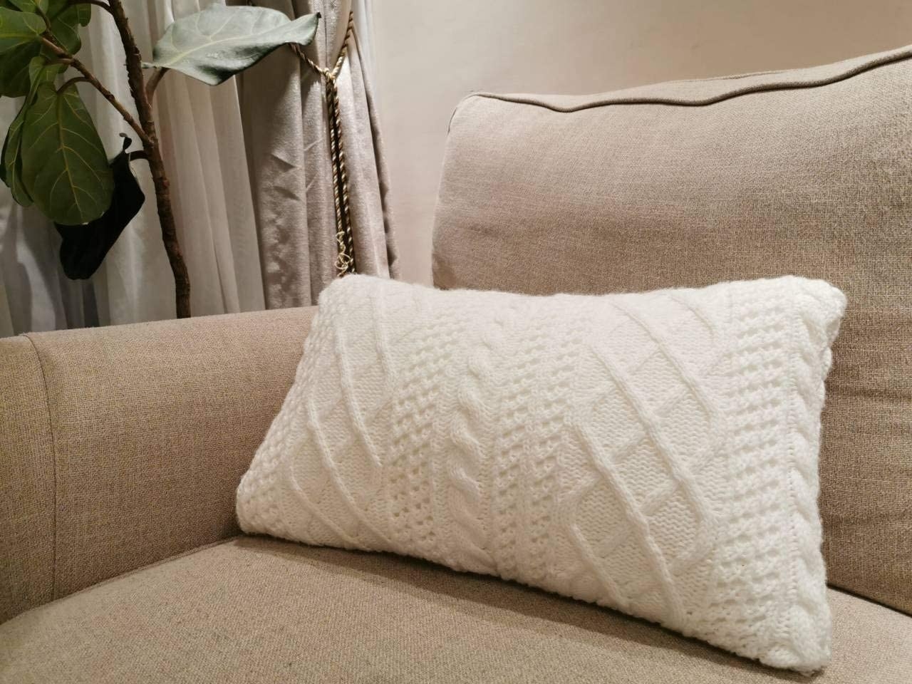 couch with white sweater-like pillow cover on it