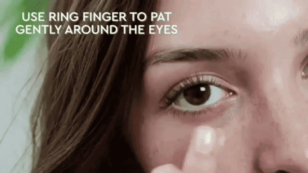 GIF of model applying eye cream. &quot;Use ring finger to pat gently around the eyes&quot;