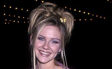 Kirsten Dunst with a messy updo hairstyle and butterfly clip in hair