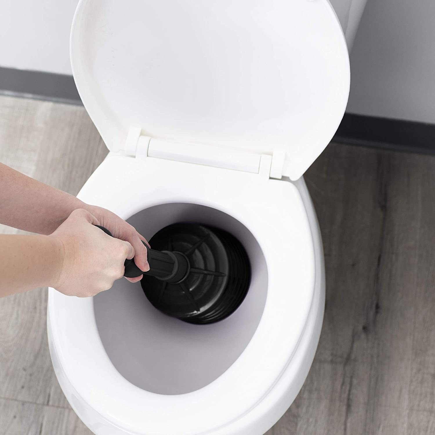 the plunger being used in a toilet 