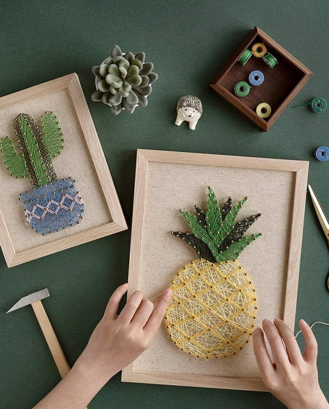 A model working on pineapple string art