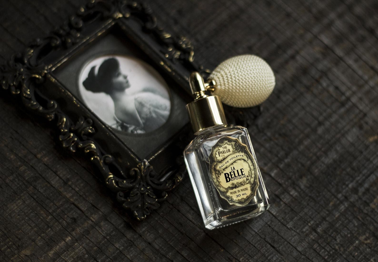 tiny perfume bottle next to an old photo