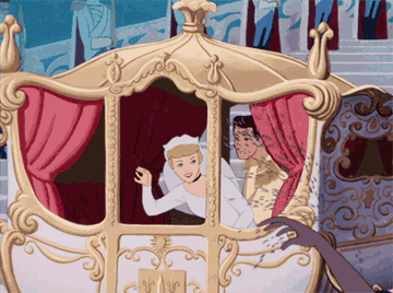 Cinderella and Prince Charming waving to a crowd