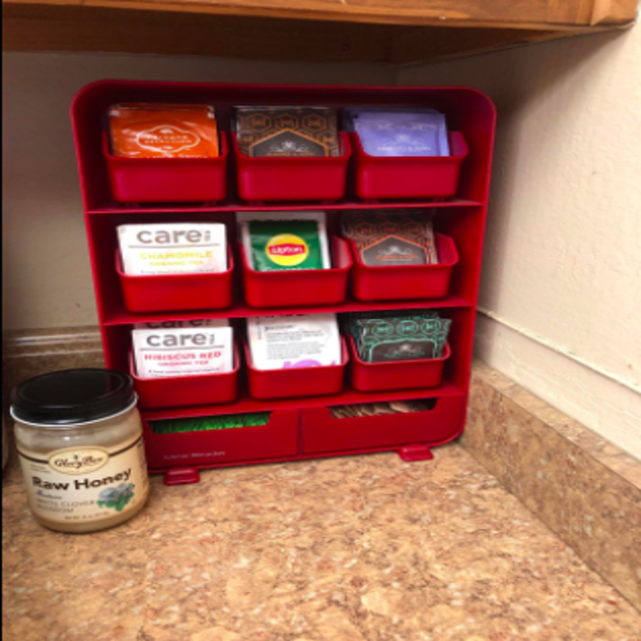 reviewer pic of a red plastic vertical organizer with removable compartments for filing tea bags