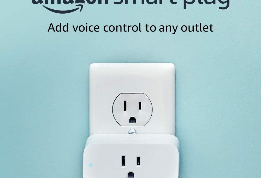 A white smart plug in a wall electrical outlet