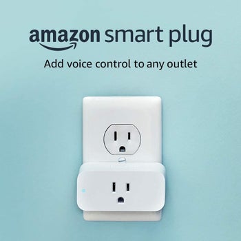 A white smart plug in a wall electrical outlet