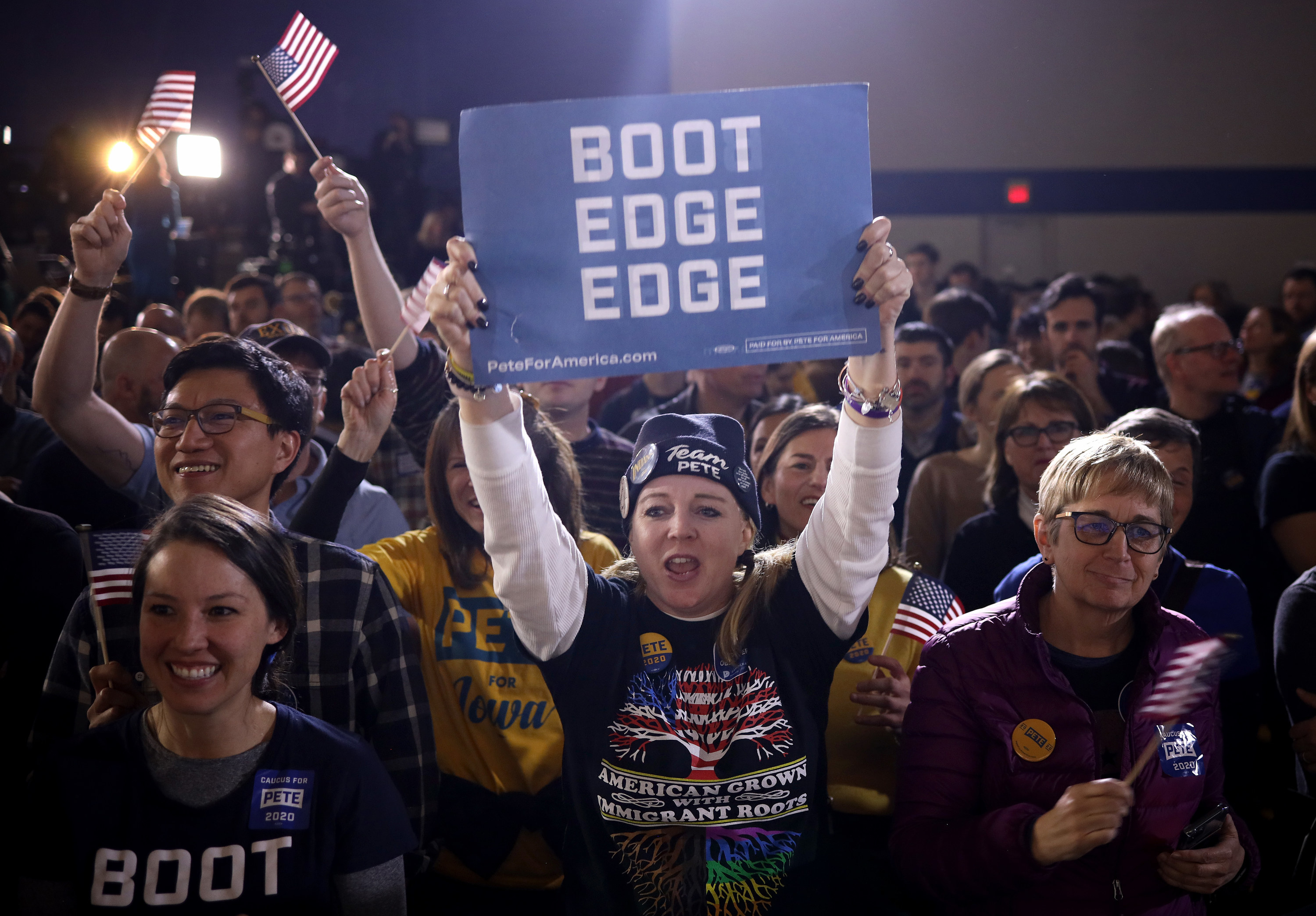  A woman at a campaign rally holding up a sign that says &quot;boot edge edge&quot;