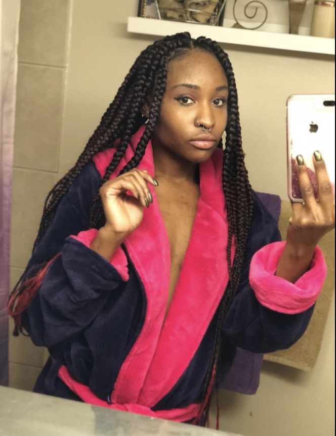 someone taking a selfie wearing a plush blue and pink robe
