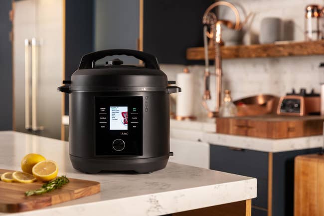 the sleek black device, which looks similar to an Instant Pot but has an LED screen and knob