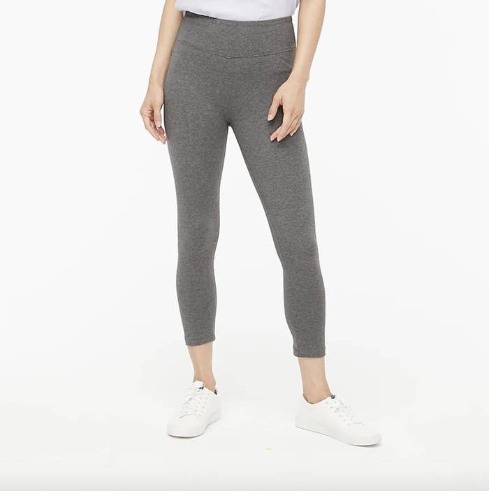 A model&#x27;s legs showing off the gray version of the leggings