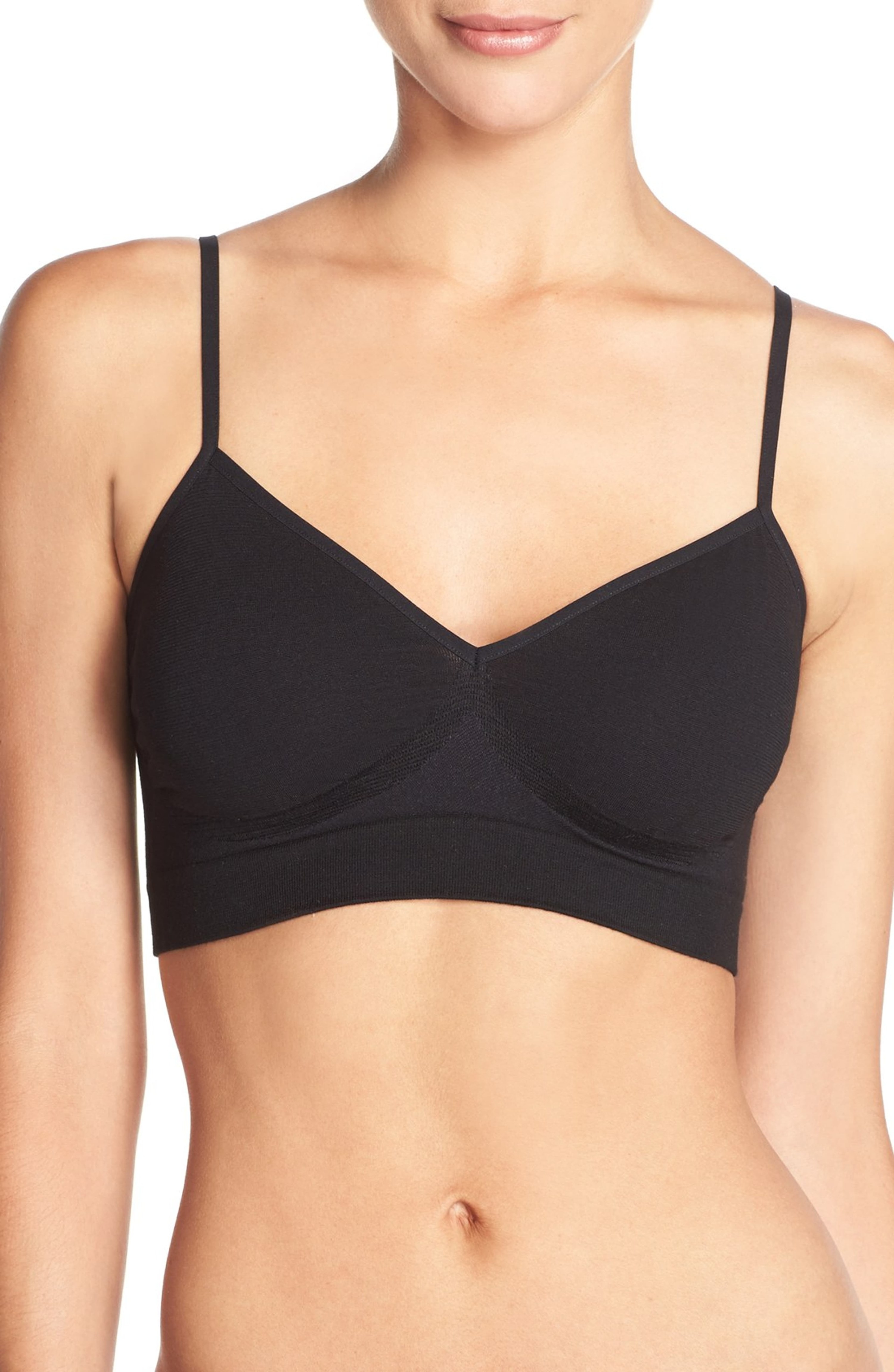 model wearing the black bra which fits like a cropped top and has spaghetti straps like a camisole or tank top
