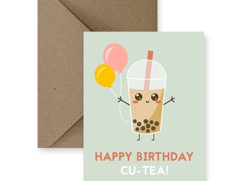 A card that reads &quot;Happy birthday cu-tea!&quot; with  an illustration of bubble tea holding balloons