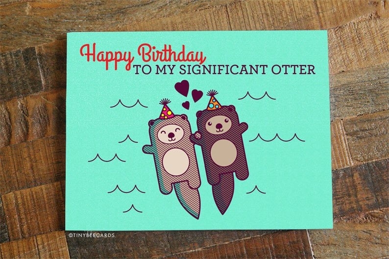A card that reads &quot;Happy birthday to my significant otter&quot; with two illustrated otters wearing party hats and holding paws