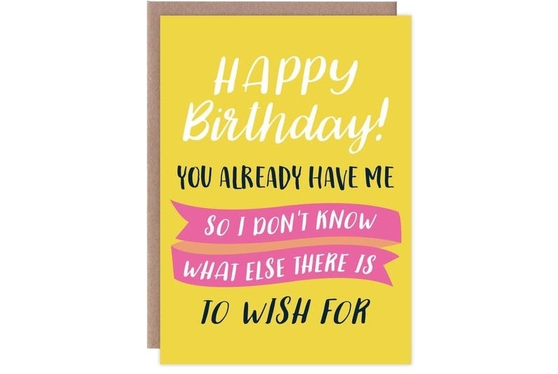 A yellow, white, black, and pink card that reads "Happy birthday! You already have me so I don't know what else there is to wish for"