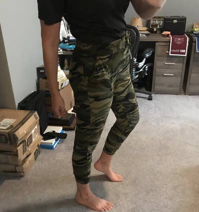 A reviewer wearing the joggers in camo (or army) print