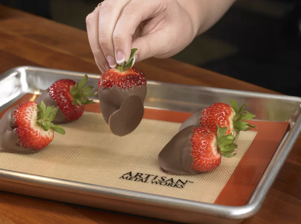 chocolate covered strawberries on top of a baking sheet